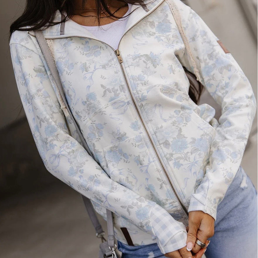 Light blue floral-patterned jacket worn by a person with a blurred background