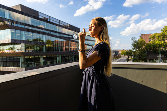Jordyn wears the navy floral maxi dress on the balcony, with Ledger in the background.