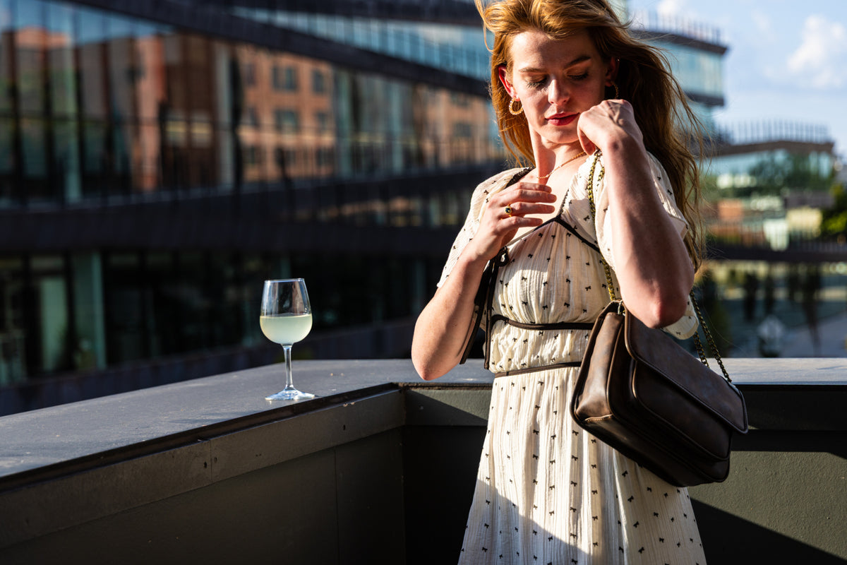 Cream bow print midi dress showing black trim and bow ties at the neckline